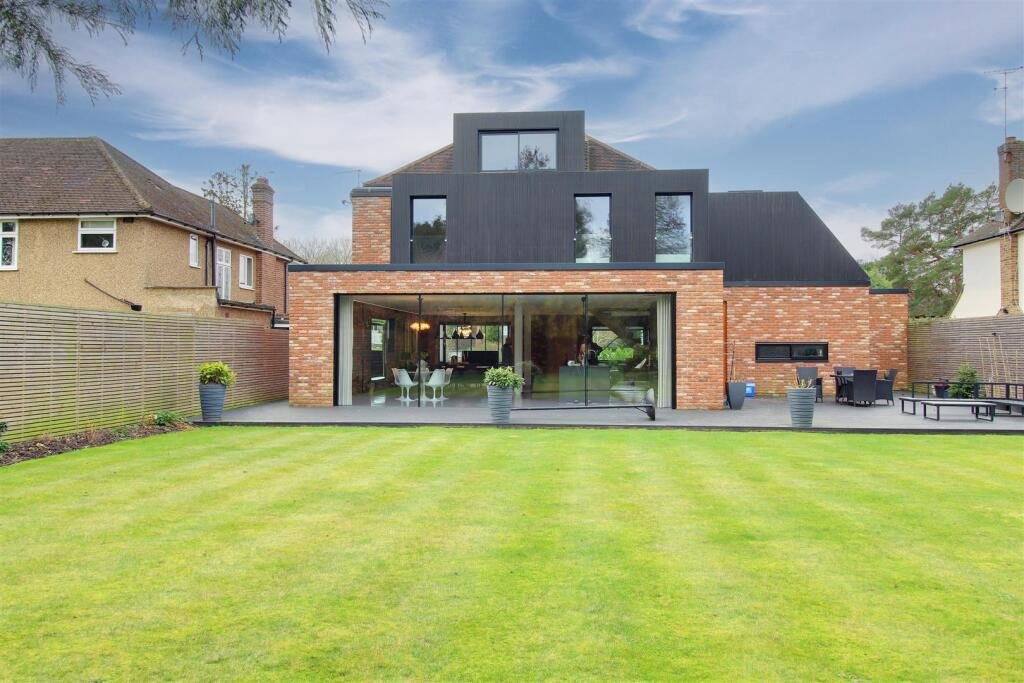 Large garden outside open patio doors of a newly refurbished house Large patio opening doors at a luxury residential project